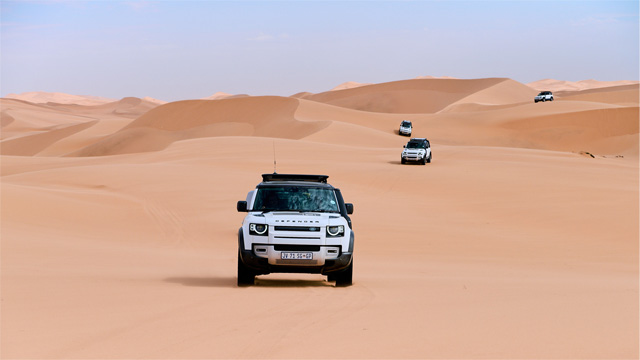 Land Rover Defender riding sand dunes in the Namib Desert near Swakopmund